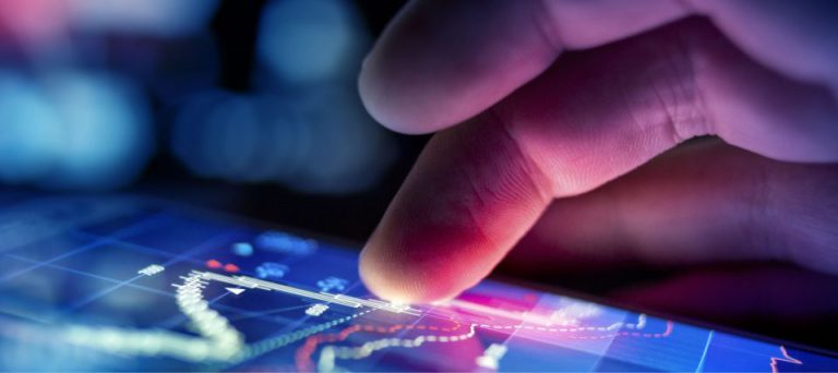A fingertip touching a glowing digital interface