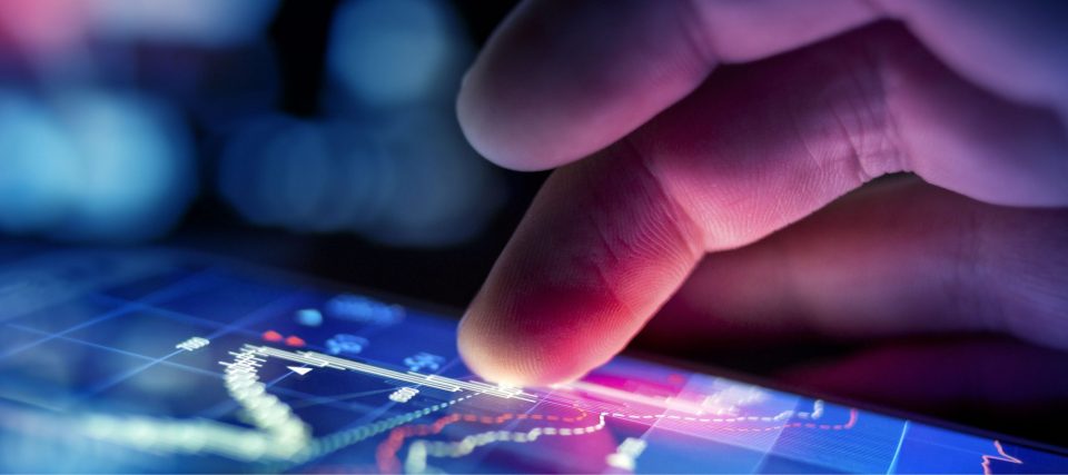 A fingertip touching a glowing digital interface