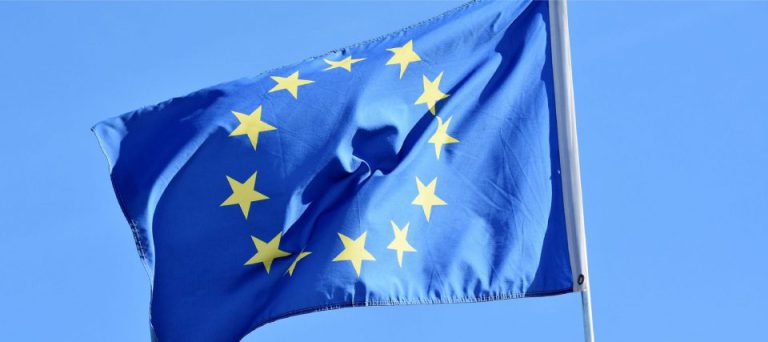 The European Union flag flying against a clear sky