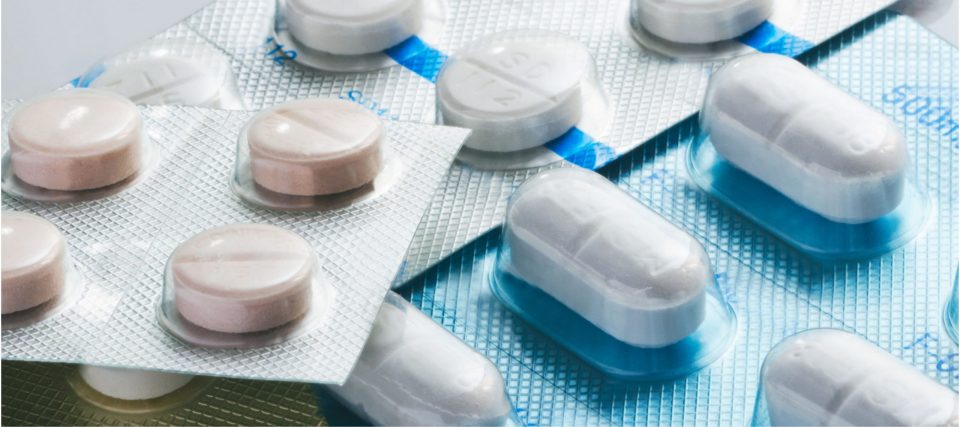 Close-up of white tablets and capsules in blister packaging
