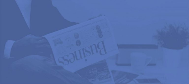 A folded newspaper business section, tinted blue