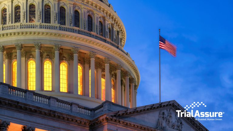 The dome of the United States Capitol at dusk with an American flag